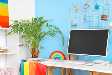Workplace with computer monitor and toy rainbow in office