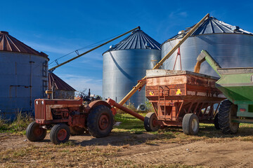 Fototapeta premium Soy bean harvest is being moved to grain silos to be sold later.