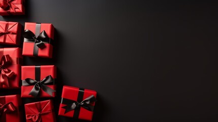 Red gift boxes are tied with a black ribbon on a black background, a symbol of promotions and sales. Holiday shopping, discounts and offers. Copy space. Boxing Day