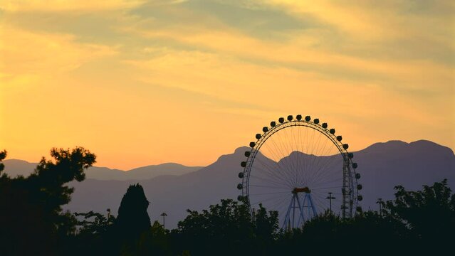 Big Ferris wheel in the amusement park at sunset in Konyaalti Antalya
