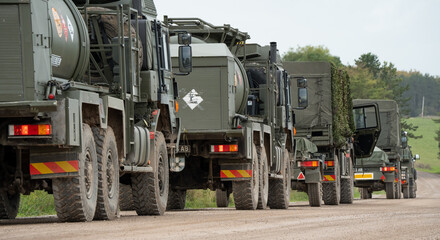 Fototapeta na wymiar convoy of British army M.A.N. HX58 unit support tankers in action on a military exercise. Wilts UK