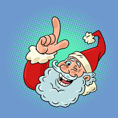 Santa claus points with his index finger. The direction of your efforts for the holiday. New Years Eve with the best mood.