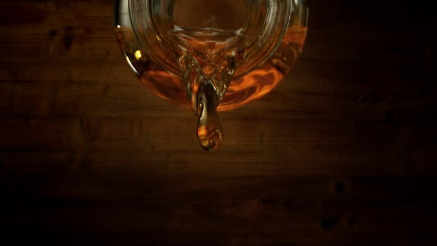 Super Slow Motion Macro Shot of Pouring Alcohol from Inside of Bottle at 1000fps with Periscope Lens.
