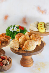 Traditional Azerbaijan holiday Novruz background with green semeni,traditional azerbaijan sweets,shekerbura,qogal,paxlava,mutaki and different nuts and sweets,top view,space for copy