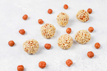 Superfood, raw healthy vegetarian snack, Medjool dates covered by chocolate, and various energy balls with nuts.