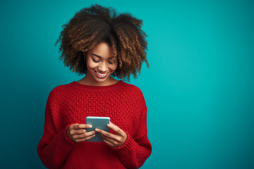 Young adult smiling happy pretty latin woman holding mobile phone looking at smartphone, typing message doing e commerce shopping using apps on cellphone isolated on plain background