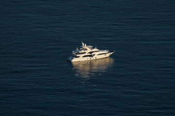 Monaco, lonely mega yacht in sea at sunset, huge motor boat, wealth life of billionaires 