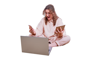 Angry woman screaming with a phone and a tablet in her hands on a home bed, isolated on a white background. Problems working online during isolation due to the coronavirus epidemic