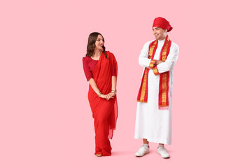 Beautiful Indian couple on pink background