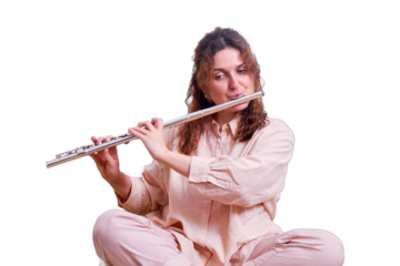 Young woman plays the flute on the bed with a cat, online music lessons, isolated on a white background. Woman with a musical instrument in her hands in the home bedroom