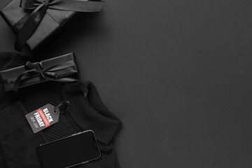 Composition with male clothes, mobile phone and gift boxes on dark background. Black Friday sale