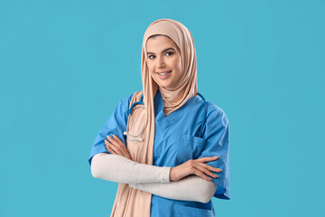 Muslim medical intern on blue background