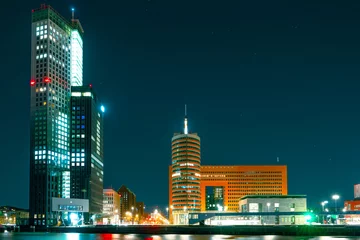 Fotobehang Spectacular Night View of Rotterdam from the Sea: Experience the Beauty of the City at Night. © Ilja