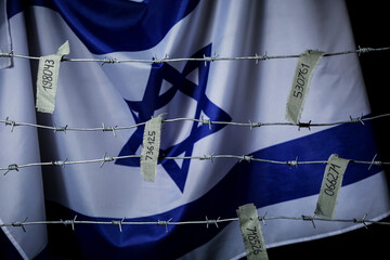 Barbed wire with prisoner numbers against flag of Israel. International Holocaust Remembrance Day