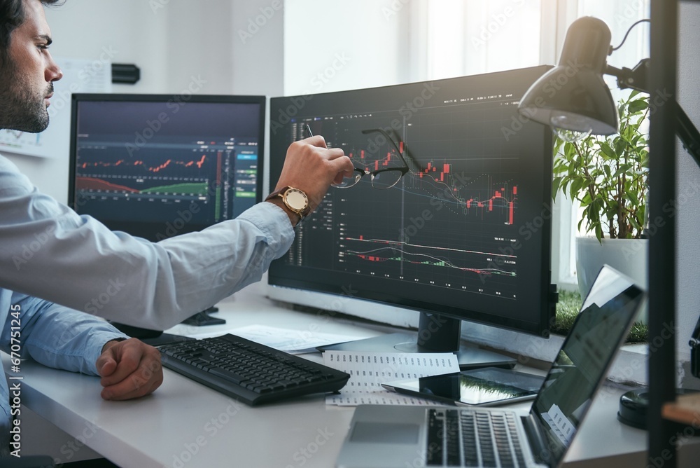 Fototapete forex market. young trader is pointing at graphs on computer screen and analyzing data while working