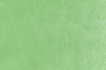 Texture background of green velours fabric. Textile structure, cloth surface, weaving of jacquard material closeup. Upholstery, curtains, backdrop, wallpaper.