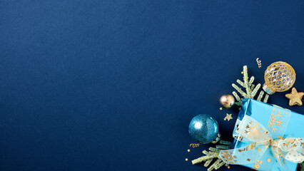 Luxury Xmas banner design. Dark blue Christmas background with gift box, fir branches, luxury ball...
