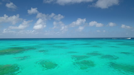 Crystal turquoise sea water under blue clouds sky in sunny day. Tourism relax and enjoy outdoor lifestyle travel on summer holiday vacation.