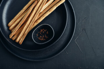 Fresh baked Italian grissini breadsticks on plate