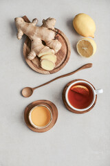 Tea  in a white cups with lemon, ginger root