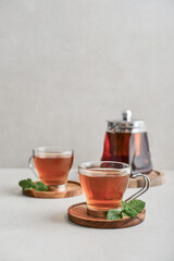 Tea  in a glass cups with  mint and glass teapot