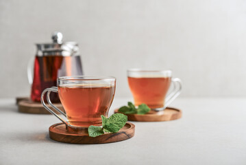 Tea  in a glass cups with  glass teapot