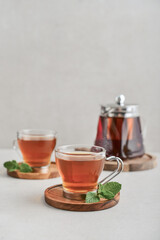 Obraz na płótnie Canvas Tea in a glass cups with glass teapot