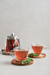 Tea  in a glass cups with  glass teapot