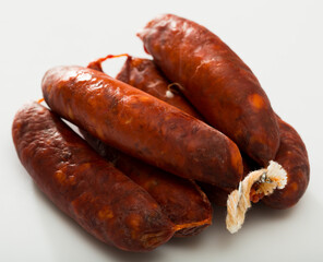 Traditional Spanish chorizo sausages on white background..