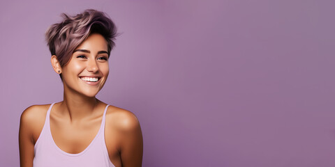 Smimilg young woman with tanned skin and short groomed hair isolated on flat violet pastel background with copy space. Model for banner of cosmetic products, beauty salon and dentistry