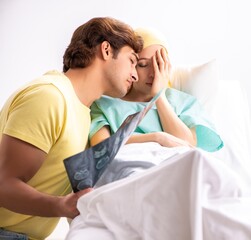 Husband looking after wife in hospital