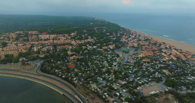 Aerial view of port Leucate with mediterranean sea in background, sunset France, Occitanie