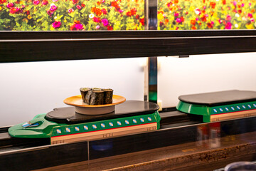 Automated food delivery in a restaurant. High speed ​​sushi train and food delivery system.