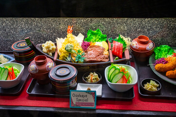 Sample food in show window at restaurant. Showcase of fake dish displayed in front of restaurant.
