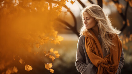 Attractive young female outdoors in nature during autumn fall, yellow and oranges leaves, background banner with copy space