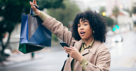 Woman, call or wave with hand for taxi by holding phone with shopping bag on street for travel. African person, manager and late for meeting, appointment or work in city with transportation commute
