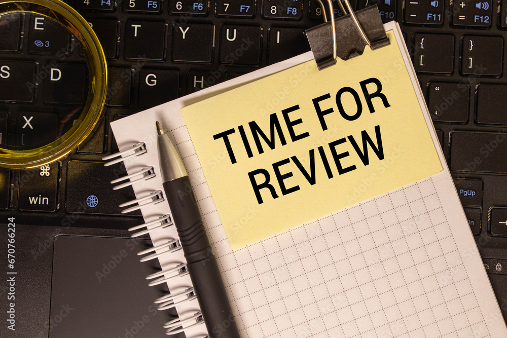 Poster time to review text on notepad with laptop on the white background