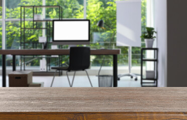 Empty wooden table in comfortable office. Space for design