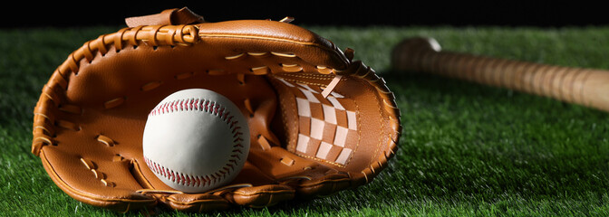 Baseball glove and ball on green grass, space for text. Banner design