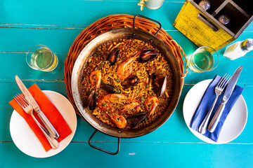 Appetizing racy seafood paella with mussels and prawns traditionally served in metal pan