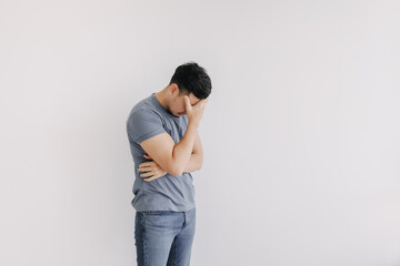 Unpleasant feeling emotion of asian man isolated on white. Depressed and Stress.