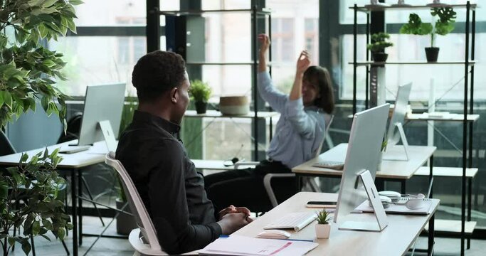 A joyful couple of entrepreneurs, filled with contentment, departs from workstations. Their smiles reflect the sense of accomplishment and fulfillment they find in their work.