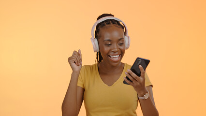 Woman, music and headset on smartphone to dance, stream podcast or excited by orange background....
