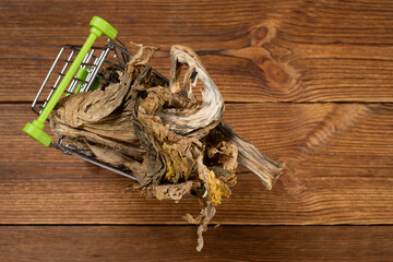 top view shopping cart with moldy vegetable concept of lack of food