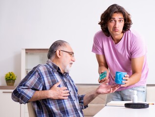 Young student and his old grandpa at home