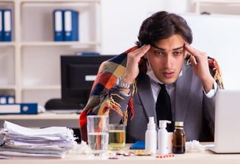 Man with flu working in the office