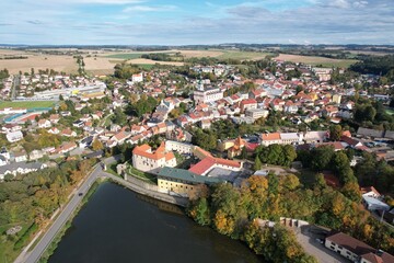 Obraz premium Polna historical city center of Bohemian town with square,column and cathedral and Polna castle,aerial panorama landscape view,Czech republic,Europe
