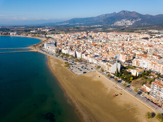 Fototapeta na wymiar Panoramic aerial view of waterfront promenade in city Roses, Catalonia