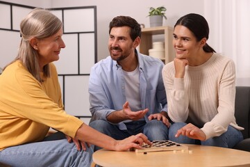 Family talking while playing checkers at home