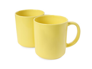 Two yellow ceramic mugs isolated on white